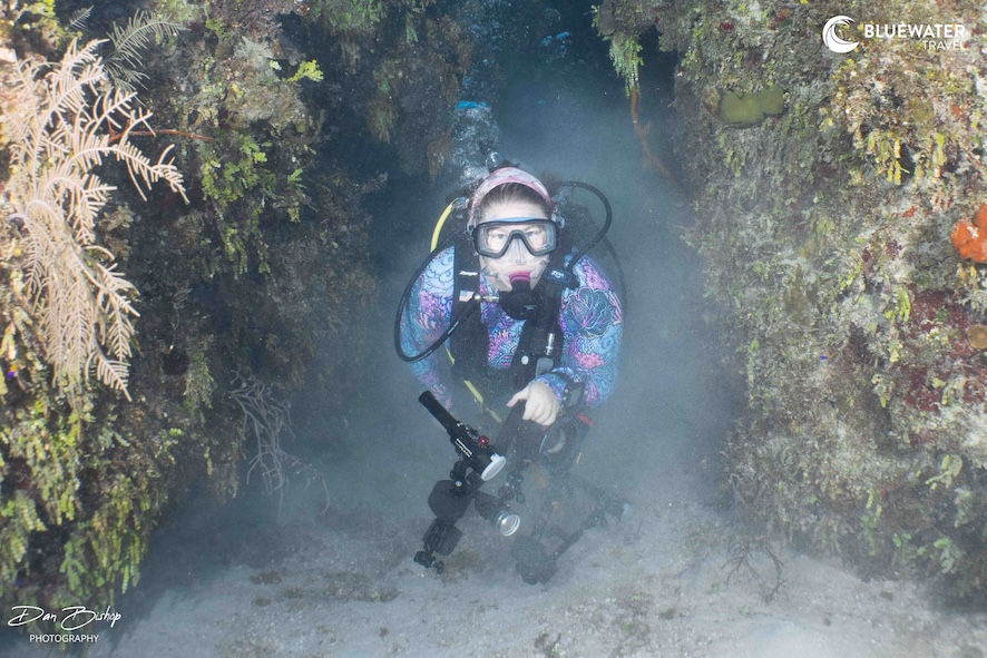 A happy diver between the corals